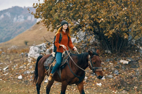 Woman hiker riding horse mountains landscape travel adventure — Stock Photo, Image