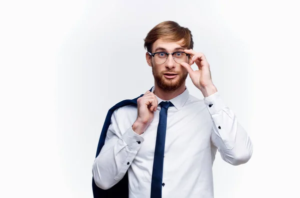 Businessman in glasses with a jacket on his shoulder and tie — Stock Photo, Image