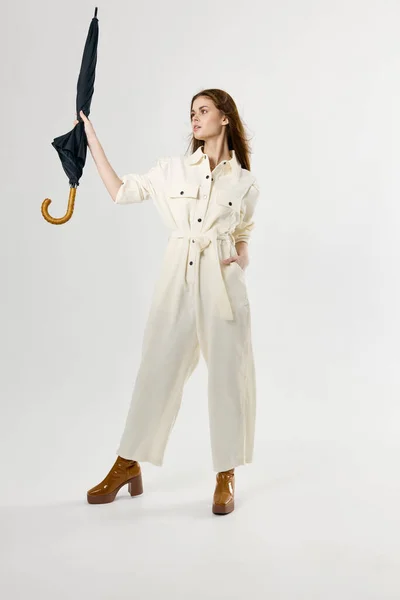 Woman in suit umbrella in hands protection from rain — ストック写真