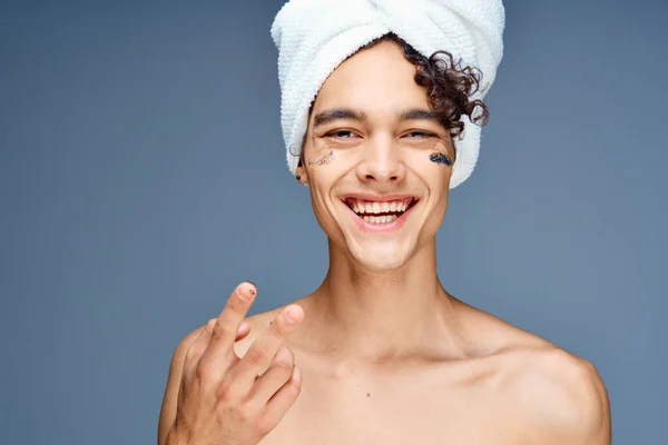 Uomo con asciugamano spalle nude sulla testa crema cosmetologia della pelle pulita — Foto Stock