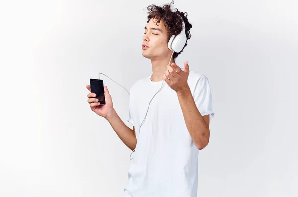 Cheerful man in headphones listens to music technology dancing — Stock Photo, Image