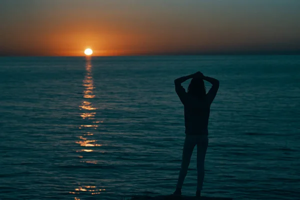 Frau am Meer bei Sonnenuntergang dunkle Silhouette und Strandmodell — Stockfoto
