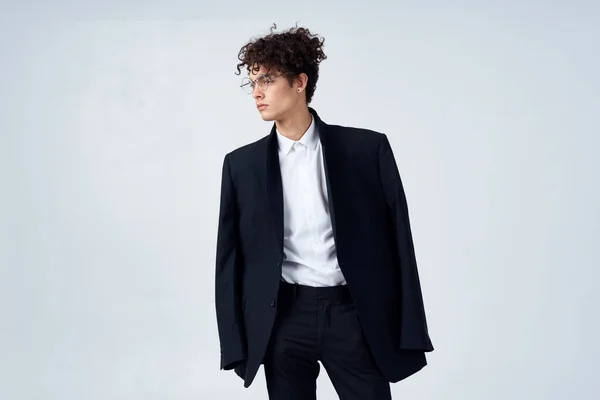 Business man in suit glasses curly hair fashion studio Stock Image