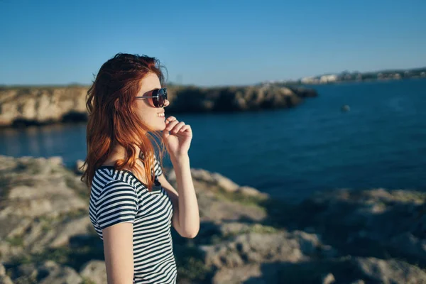 Portrait of a beautiful woman in glasses near the lake in the mountains on nature vacation model — Stock Photo, Image