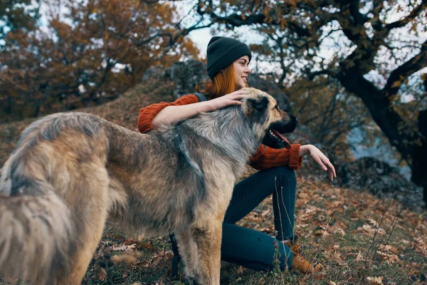 Wesoła kobieta turysta przytulając psa na świeżym powietrzu podróżować przyjaźń — Zdjęcie stockowe