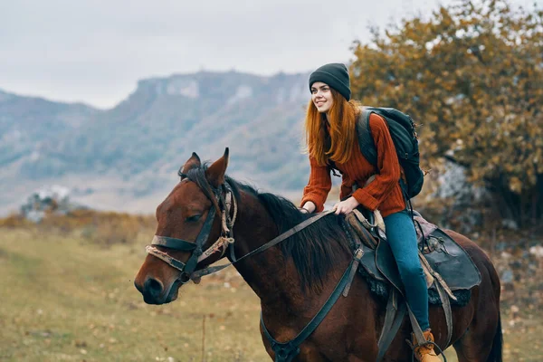 Cheerful woman Tourist riding a horse nature mountains joy — Stock Photo, Image