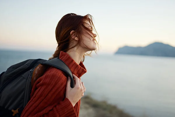 woman in sweater resting in the mountains outdoors vacation travel tourism