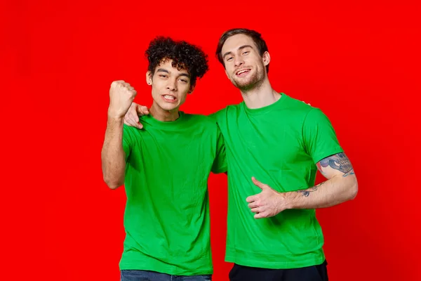 Cheerful friends green t-shirts emotions communication hug friendship