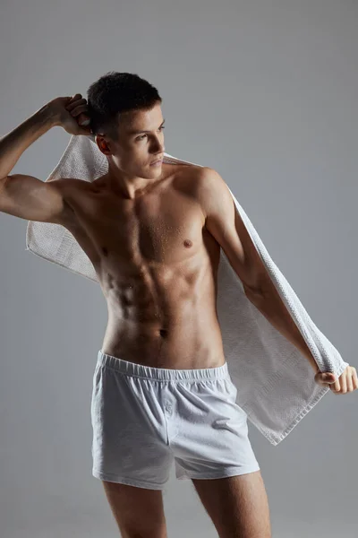 Sporty man with muscular torso white towel — Stock Photo, Image