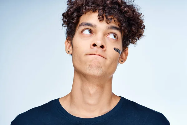 Tipo de pelo rizado en una camiseta de cosméticos negros en la cara piel limpia —  Fotos de Stock