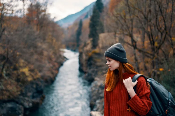 Woman hiker on the bridge near the river mountains travel nature — Stock Photo, Image