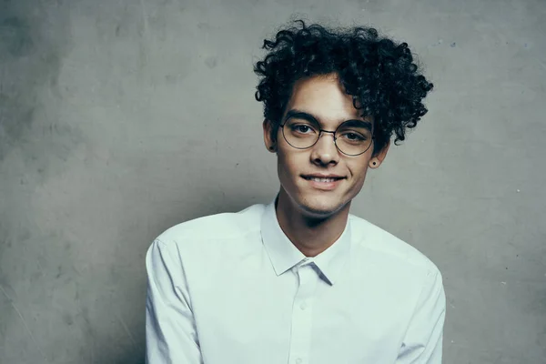 Portrait of a happy guy with glasses curly hair white shirt photoshoot model — Stock Photo, Image