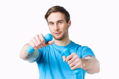 Dambıllı mavi tişörtlü adam.