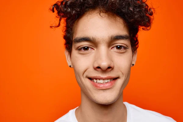 cute guy curly hair white t-shirt modern style orange background