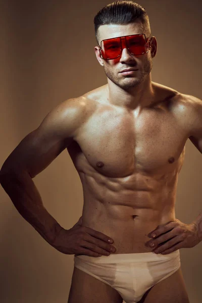 Sporty man with muscular body fashion glasses white underpants posing — Photo