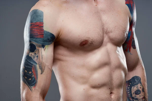 man with pumped up press tattoo on his arms cropped view of workout