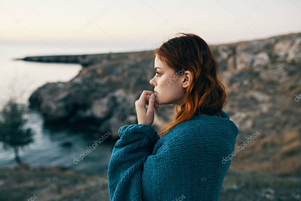 woman travels in the mountains on nature in the lake and blue plaid