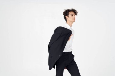 Elinde siyah bir ceket tutan adam modern tarz özgüven stüdyosu.