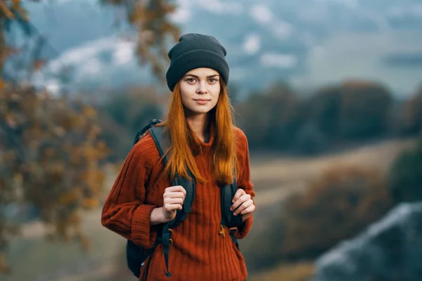 woman with backpack in mountains nature autumn adventure