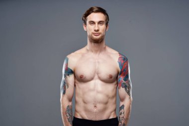 Kollarında dövmeleri olan sporcu bir adam...