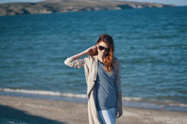 Gezgin, deniz kıyısındaki sahillerde gezinir. Dağlarda dalgalar, yaz mevsiminde.