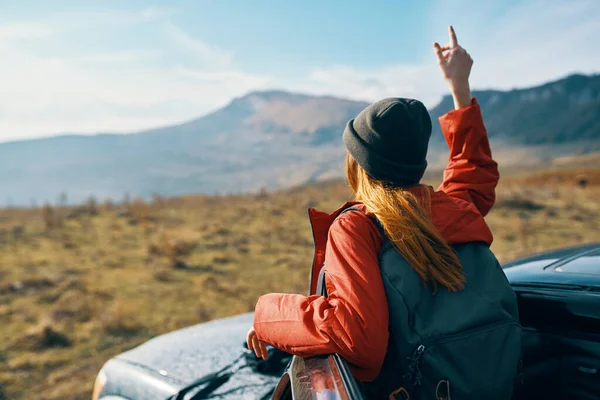 Mujer cerca de coches haciendo gestos con sus manos en la naturaleza en las montañas mochila de otoño turismo de viajes — Foto de Stock