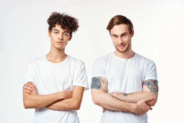 Due uomini in bianco t-shirt stare fianco a fianco ritagliato vista studio amicizia — Foto Stock