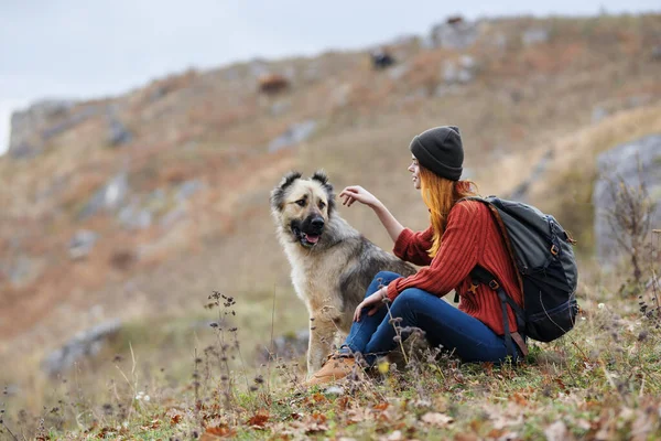 Woman in mountains outdoors with dog friendship travel landscape — Stock Photo, Image