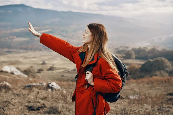 Travel woman with backpack rest in the mountains on nature landscape tourism