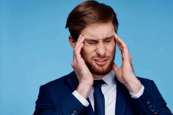man in a suit holding his head displeased businessman