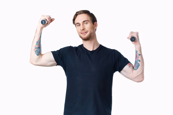 Uomo con manubri muscoli bodybuilder fitness e tatuaggio sul braccio — Foto Stock