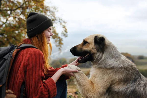 Woman hiker playing with dog nature travel friendship — Stock Photo, Image