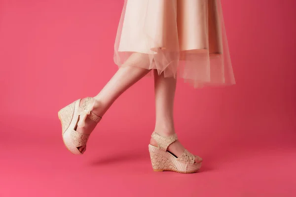 Female legs in shoes dress cropped view pink background posing — Stock Photo, Image