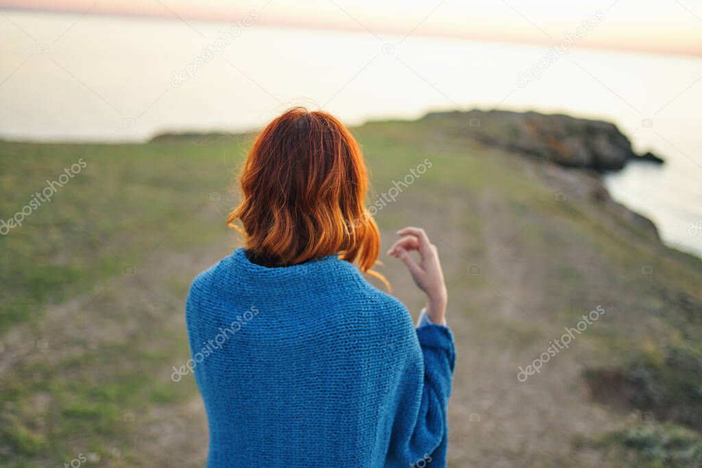 woman hiker admires nature landscape river back view