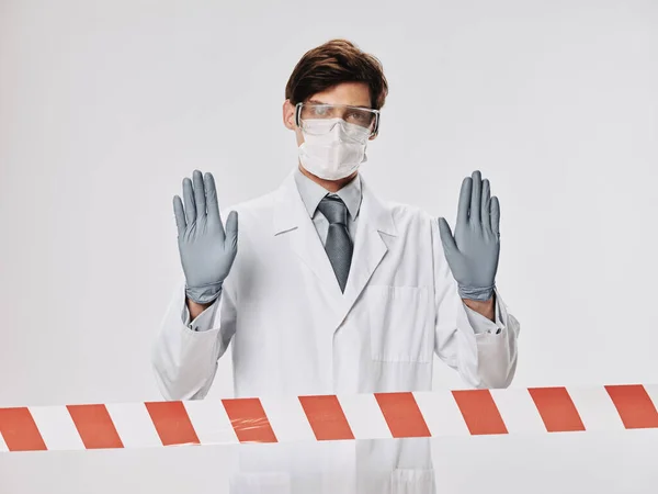 Doctor medical mask and gloves white coat light background cropped view — Stok Foto