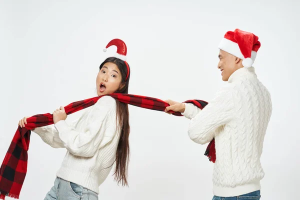 Young couple of asian appearance in winter clothes emotions christmas holiday — Stockfoto