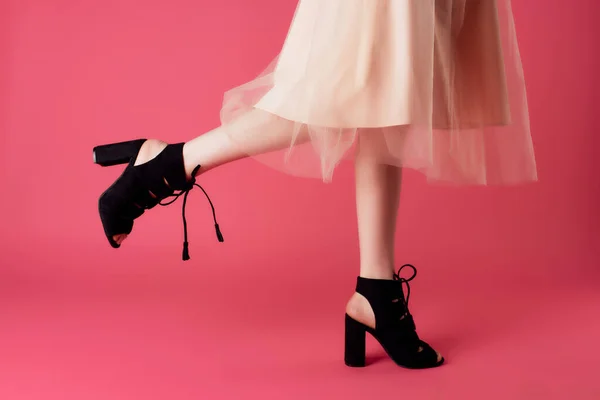 Woman in black shoes cropped view posing fashion glamor pink background — Stock Photo, Image