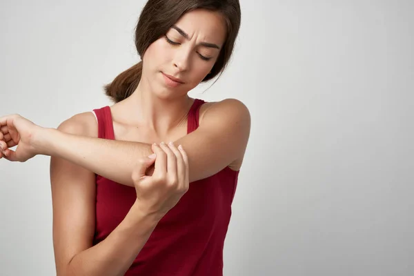 Kırmızı tişörtlü kadın eklem ağrısı, tatminsizlik sağlık sorunları — Stok fotoğraf