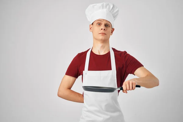 Chef with a cap on his head Frying pan in his hands preparing food — Stock Photo, Image