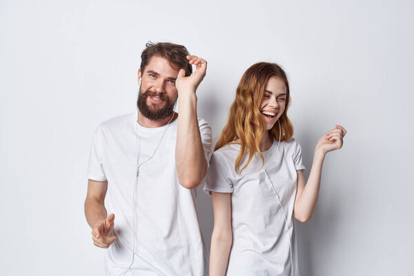 young couple in white t-shirts fun entertainment friendship positive