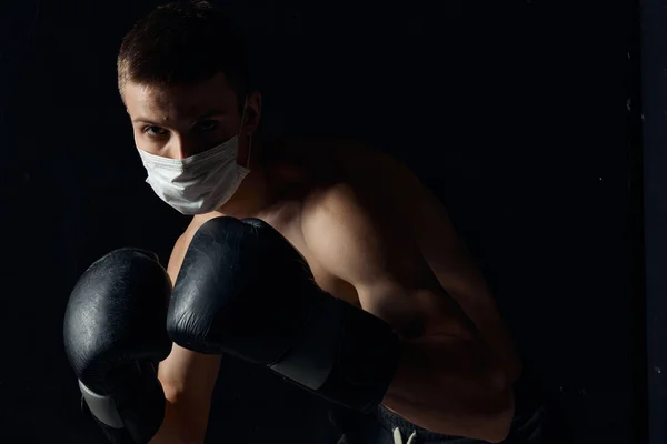 Guy in medical mask and in boxing gloves on isolated background cropped view Copy Space — Stock Photo, Image