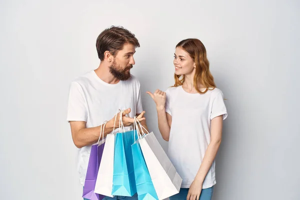 Joven pareja con bolsas en manos compras venta divertido — Foto de Stock