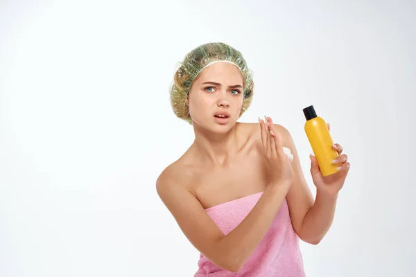 Woman with unhappy facial expression in pink towel lotion skin care — Stock Photo, Image