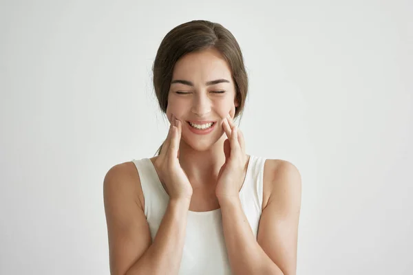 Woman in white t-shirt holding face toothache discontent close up — Stock Photo, Image