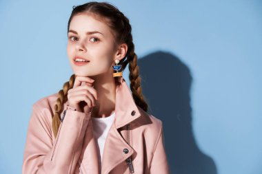 Pembe ceketli güzel bir kadın parlak makyaj cazibesi gençlik tarzı mavi arka plan