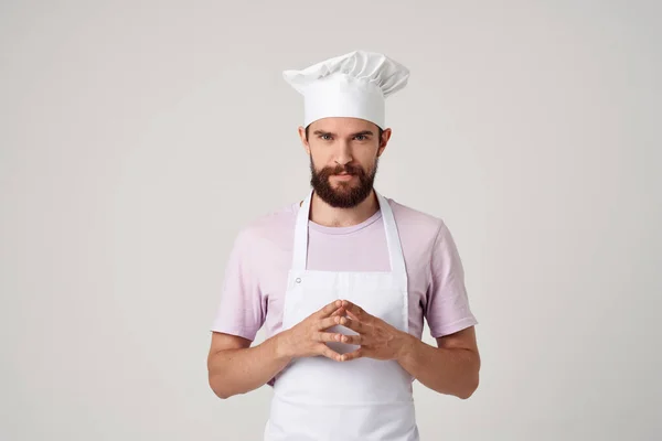 Man in chefs clothes cooking food kitchen profession light background — Stock Photo, Image