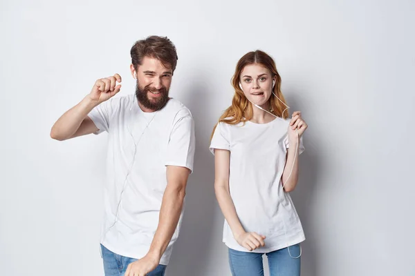 Cheerful young couple in white t-shirts entertainment emotions friendship positive — Stock Photo, Image
