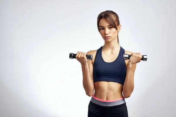 Sportive woman with dumbbells in hands pumped up press fitness exercise gym — Stock Photo, Image