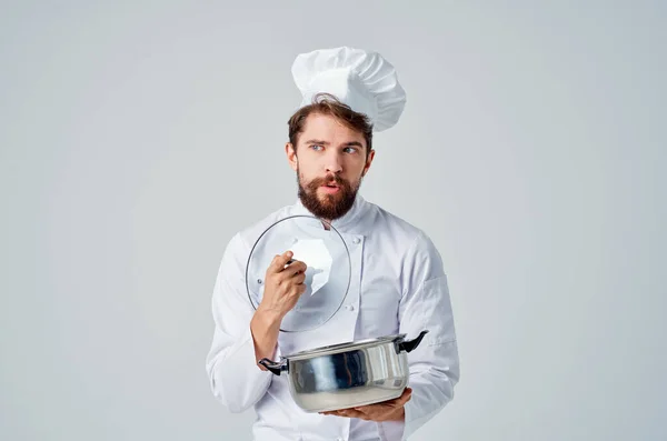 a man in a chef\'s uniform  cooking . High quality photo