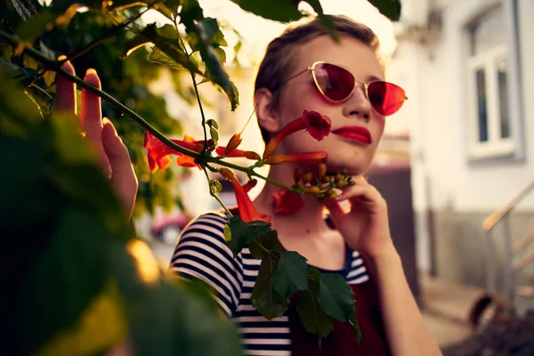 Mulher bonita usando óculos de sol ao ar livre flores decoração posando — Fotografia de Stock